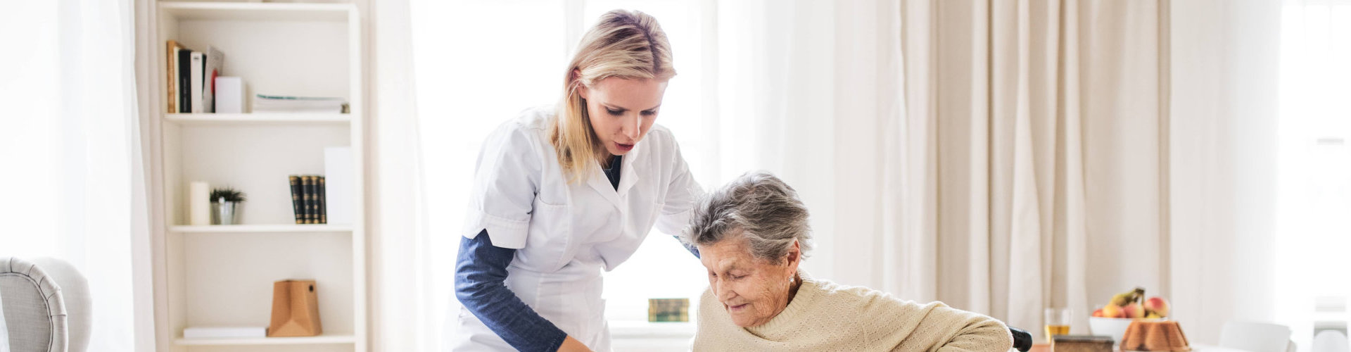 caregiver assisted to her old woman patient