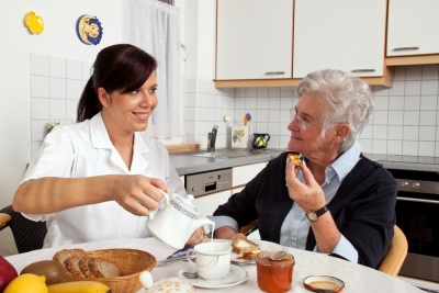 female caregiver preparing coffee to her patient