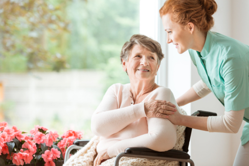 elderly woman holding on caregivers hand