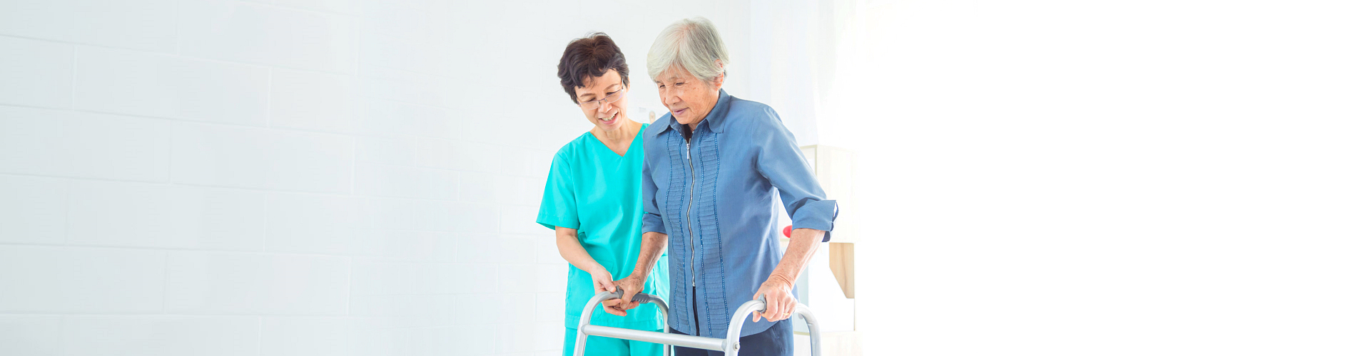 female caregiver assisting to her patient to walk