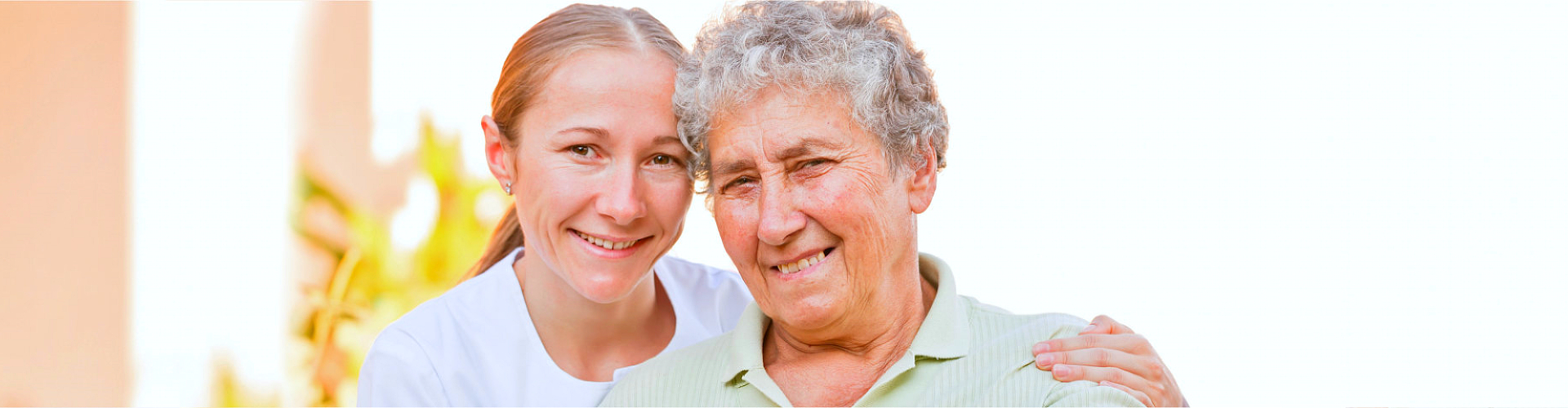 smiling old woman and caregiver