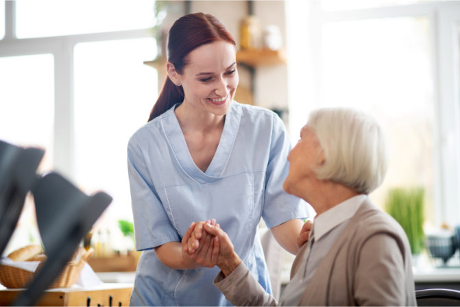 caregiver holding patients hand