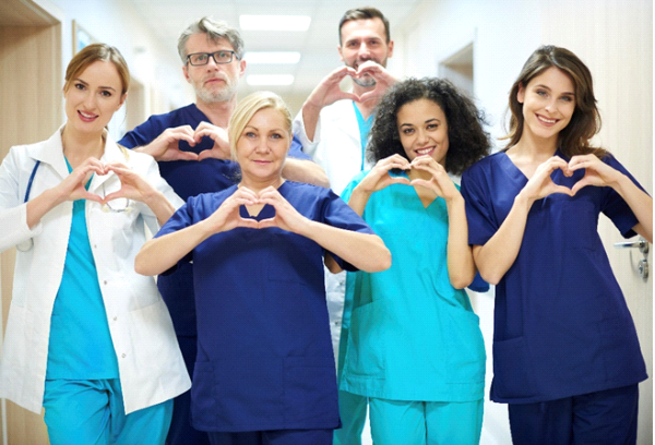 medical staff doing heart shape hand sign